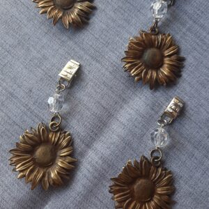 PESA MANTEL GIRASOL EN COLOR PLATA O BRONCE
